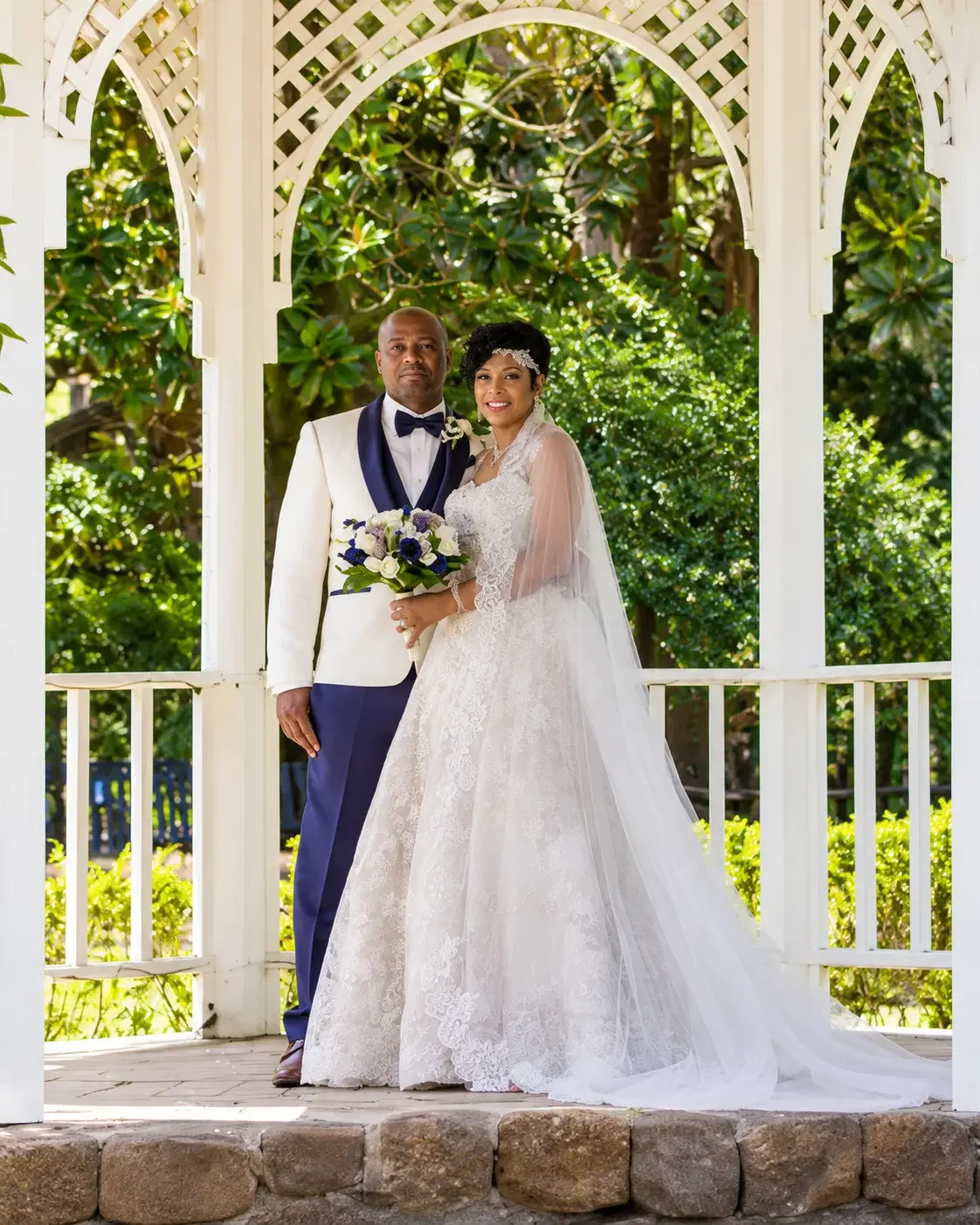Lace bridal gown with sheer sleeves and flowing veil