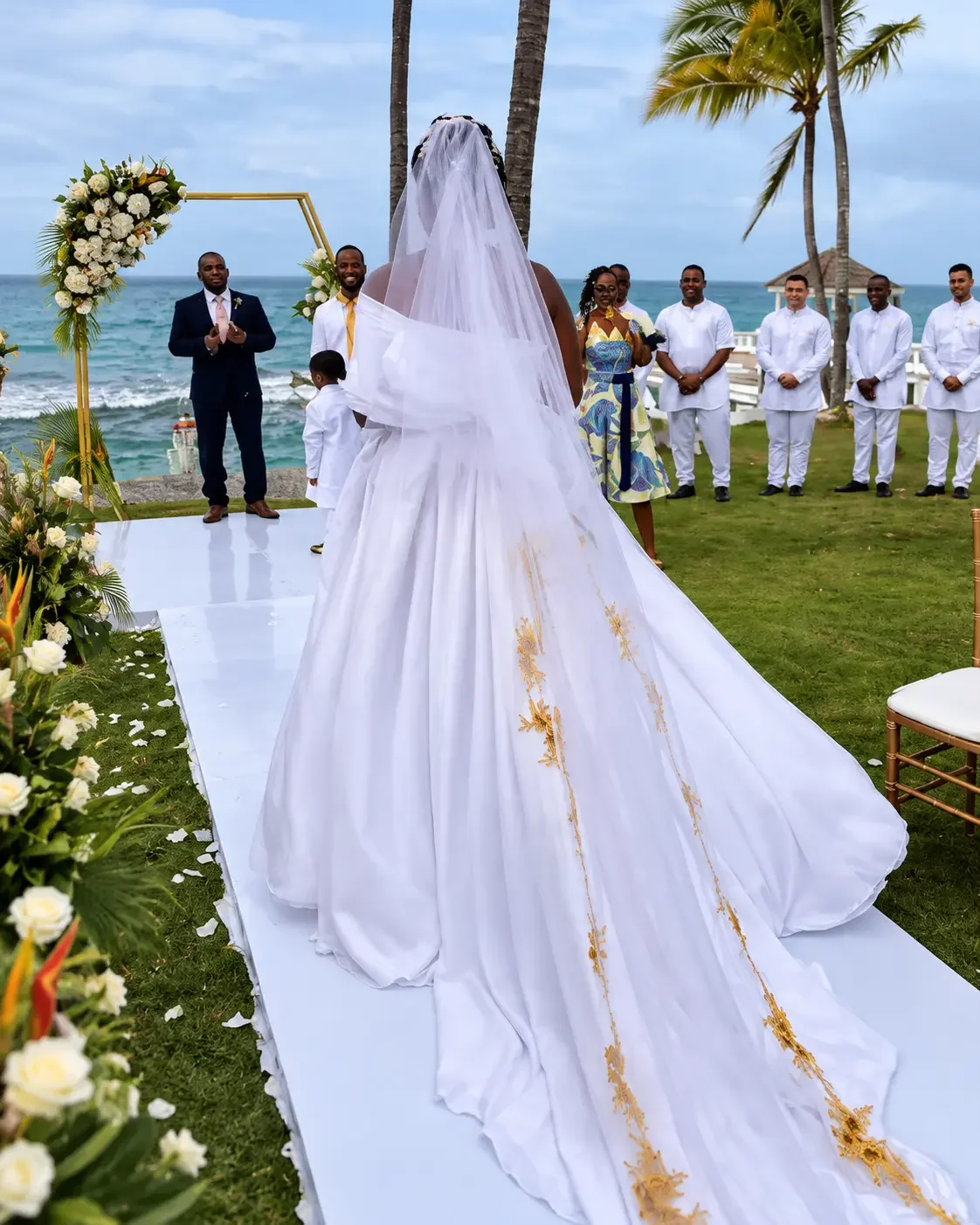 White wedding gown with gold-embroidered train and long veil